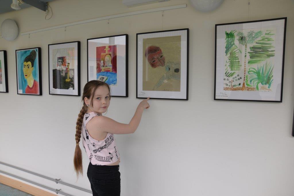 Young painter is showing her drawings